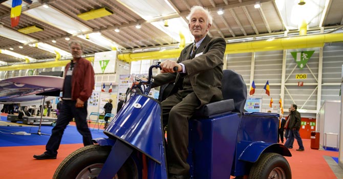 Irish James Dower presents his invention - a three-wheeled vehicule with a tilting mechanism. —Photo by AFP