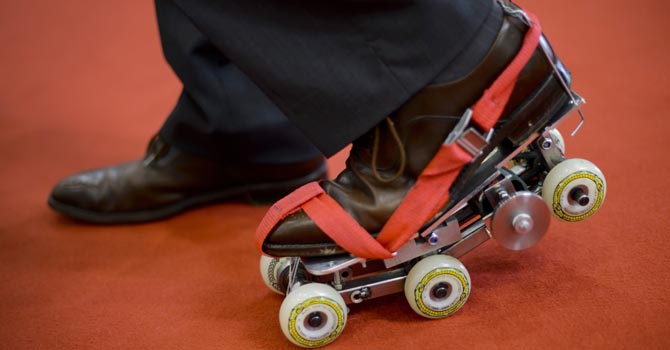 French inventor Paul Chavand presents his creation - shoes fitted with mechanisms of inertia to achieve a speed of 10kms per hour, allowing walking at higher speeds, without any skating movements. —Photo by AFP
