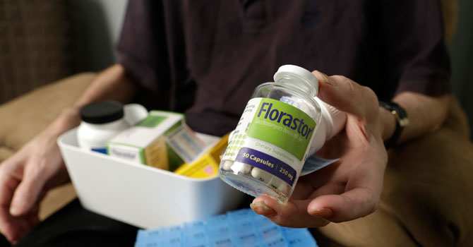 Michael Claes, 62, who contracted a superbug while in the hospital, shows a bottle of one of his daily medications as he recovers at home in New York. Claes caught a bad case of a diarrheal illness caused by Clostridium dificile, while he was a kidney patient at New York City's Lenox Hill Hospital in fall 2012. —AP Photo