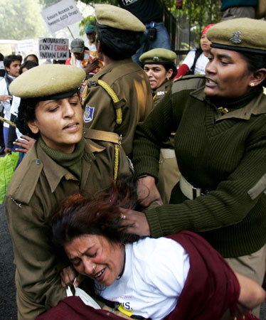 Indian police officers block demonstrators protesting against drug manufacturer Novartis' case against Indian government on drug patents in New Delhi, India years back. —Photo (File) AP