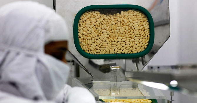 A pharmacist works in a lab where medicines are being produced at a Cipla manufacturing unit on the outskirts of Mumbai, India. —Photo (File) AP
