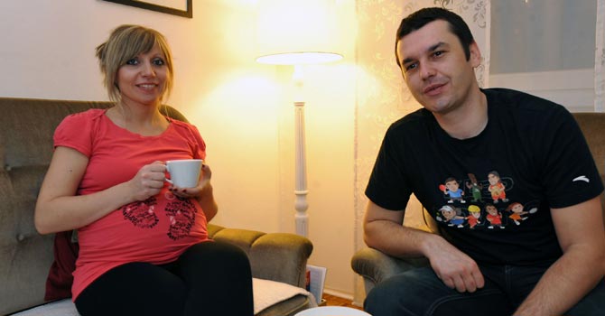 Bosnian Muslim, Rusmir Zaimovic (33) and his wife, Bosnian Catholic, Sandra (32), enjoy an afternoon coffee at their apartment in Sarajevo. —Photo by AFP