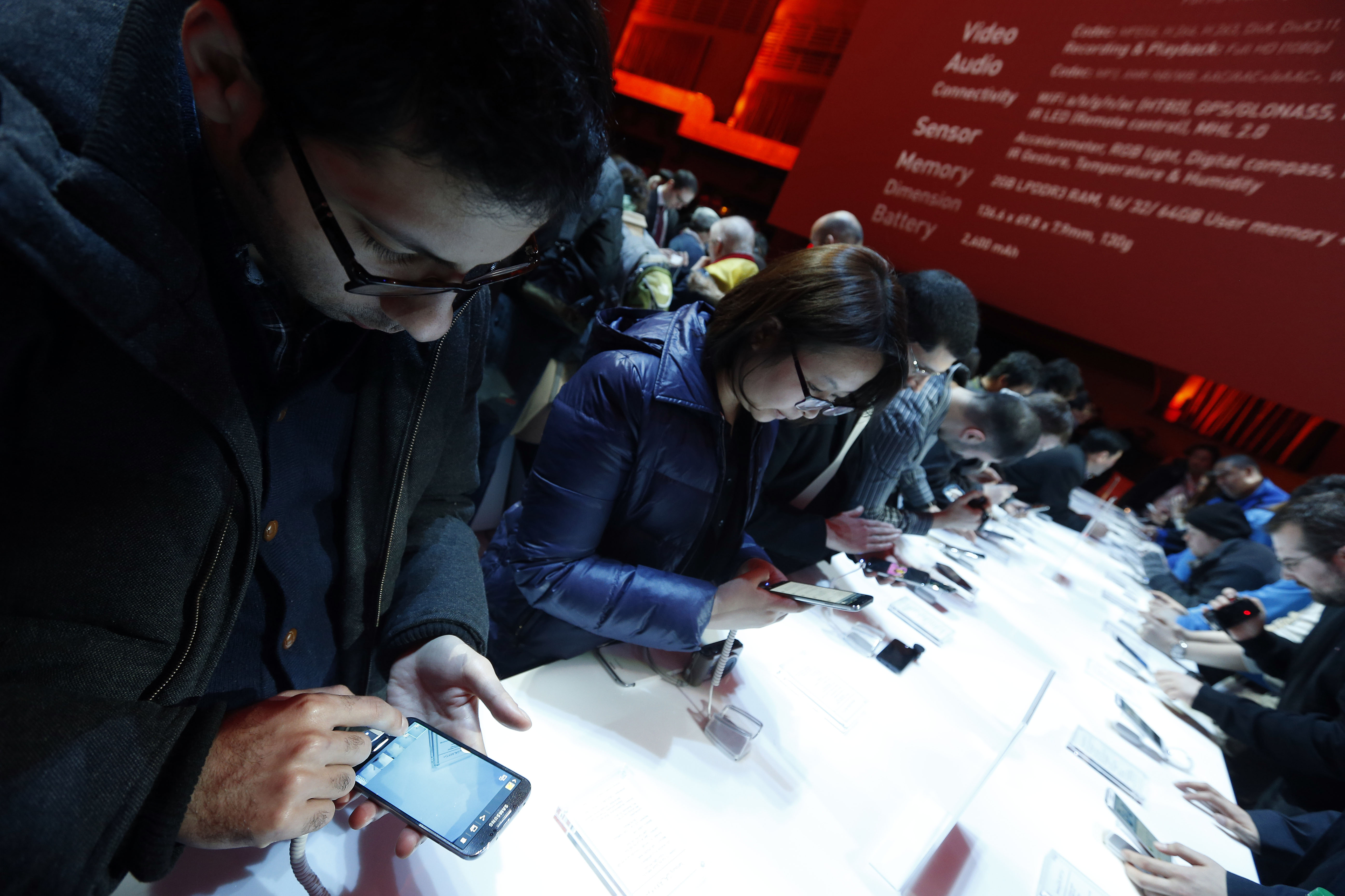 Attendees try out the new Samsung Galaxy S 4 during the Samsung Unpacked event at Radio City Music Hall, Thursday, March 14, 2013 in New York.  (AP Photo/Jason DeCrow)