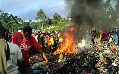 In this photo last February, bystanders watch as a woman accused of witchcraft is burned alive in the Western Highlands provincial capital of Mount Hagen in Papua New Guinea. —AP (File) Photo