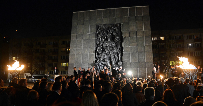 People gather in front of the monument dedicated to the fighters of the Warsaw ghetto uprising for the evening commemorations on the eve of the 70th anniversary of this1943 revolt. —AFP Photo