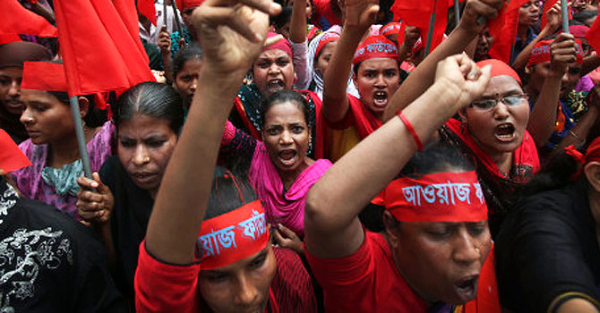 Protesters shout slogans calling for better working conditions for garment workers during a May Day rally. —AP (File) Photo
