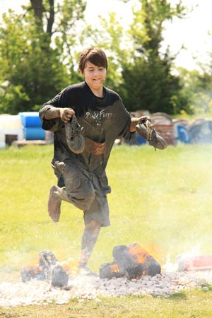 A contestant in the Fire Jump competing during The Survival Race in Dallas. —AP Photo