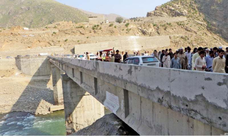 Local people take a walk on the newly-built bridge in Barang tehsil of Bajaur Agency. — Dawn
