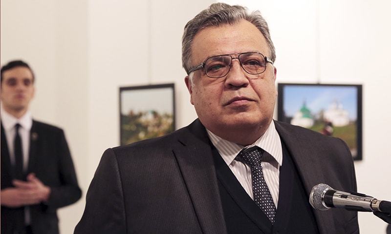 Andrei Karlov, the Russian Ambassador to Turkey, speaks at a photo exhibition in Ankara. -AP