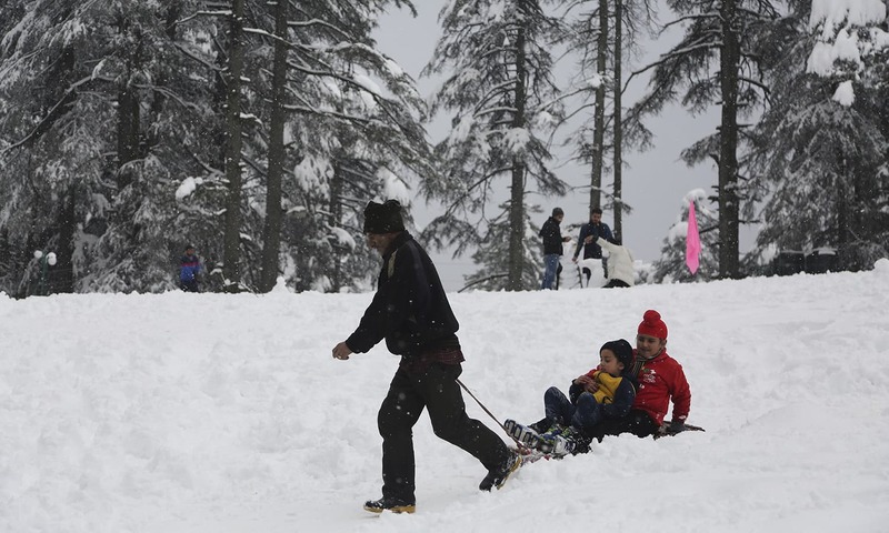 A man pulls a tourist on a sledge through snow at Patnitop in Udhampur district of Jammu and Kashmir state.─AP
