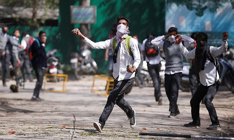 A Kashmiri student throws a piece of stone during a protest in Srinagar April 17. ─Reuters