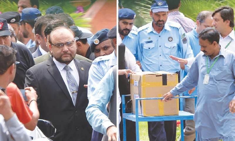 Police and court officials transport a box of final evidence presented by the JIT at the Supreme Court. &mdash; AFP