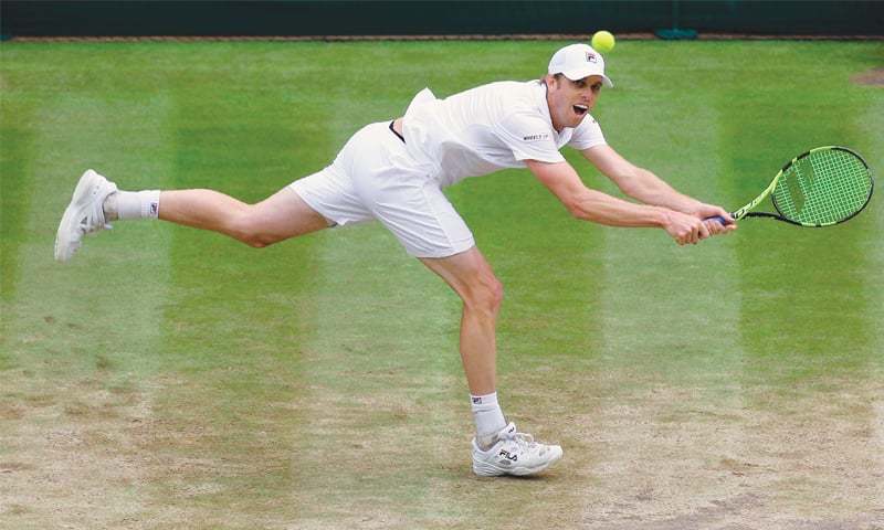 LONDON Sam Querrey of the US hits a return to Croatia’s Marin Cilic during the Wimbledon semi-final on Friday.—AFP