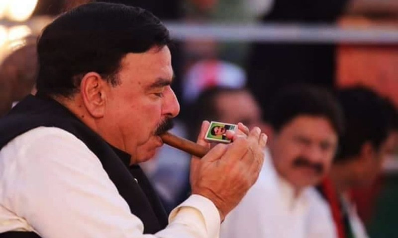 Sheikh Rashid lights up a signature cigar with matches branded with his name. — Photo Courtesy: Facebook