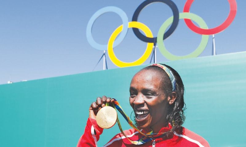 IN this  file photo taken on Aug 14, 2016 Jemima Jelagat Sumgong poses with her gold medal after the podium ceremony of the Rio Olympic Games.
—AFP
