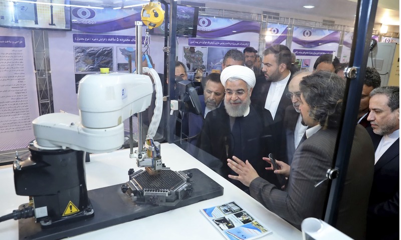 Hassan Rouhani is briefed about nuclear achievements during a ceremony in Tehran to mark