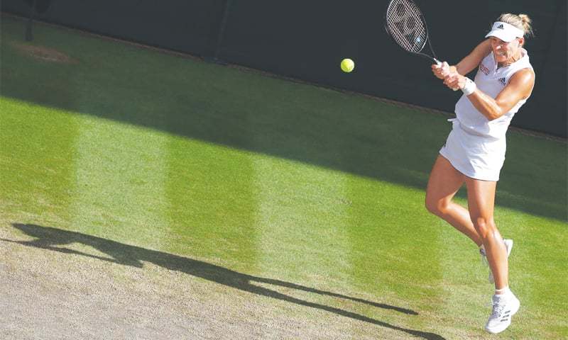 LONDON Angelique Kerber hits a return to Serena Williams during the Wimbledon final on Saturday.—AFP