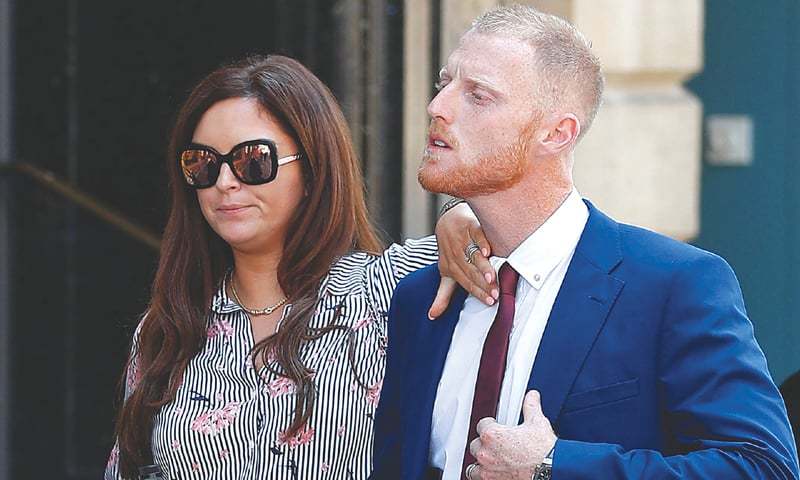 BRISTOL Clare Stokes, wife of England cricketer Ben Stokes sorts out her husband’s collar as they return to Bristol Crown Court after a lunch break on Monday.—AFP