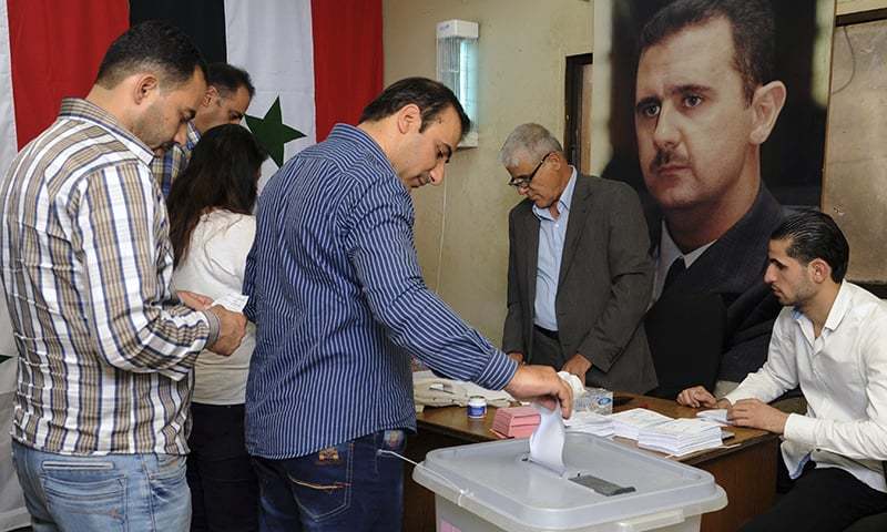 Syrians cast their votes at a polling station during municipal elections in Damascus Syria. —AP