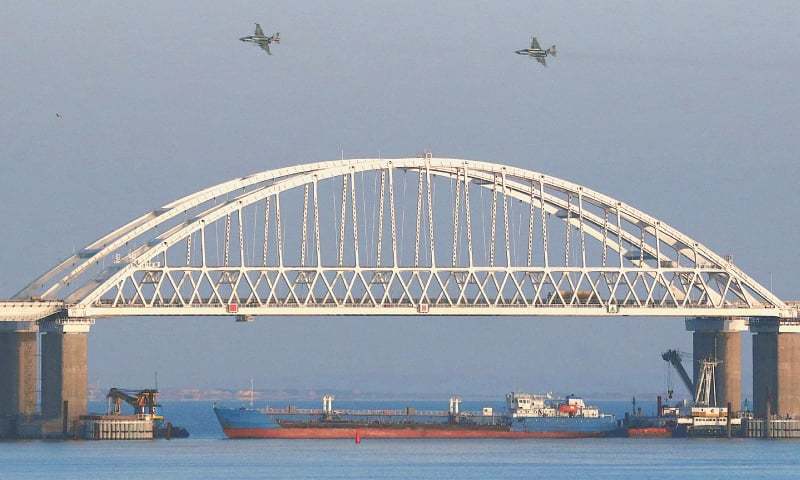 Russian fighters fly over a bridge connecting the Russian mainland with the Crimean peninsula after three Ukrainian navy vessels were stopped from entering the Sea of Azov.—Reuters