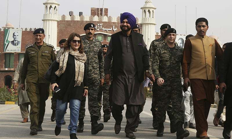 Former Indian cricketer-turned-politician Navjot Singh Sidhu, centre, arrives at the Pakistani border post Wagah near Lahore on Tuesday. — AP