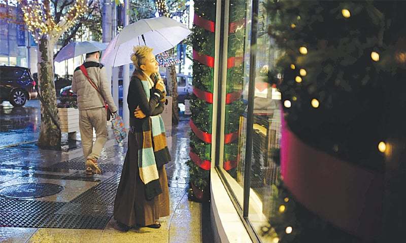 SHANGHAI: Fifty-six-year-old Chinese model Ma Yinhong standing outside a shop on a street.—AFP
