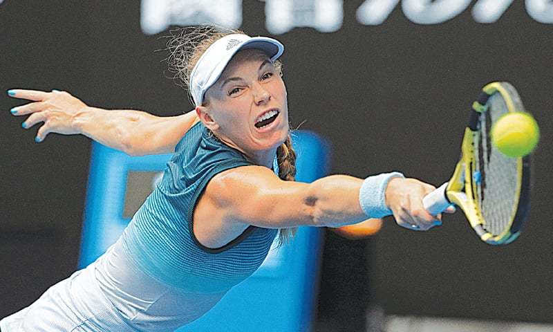 MELBOURNE: Denmark’s Caroline Wozniacki hits a backhand return to Maria Sharapova of Russia during their Australian Open third-round match on Friday.—AP