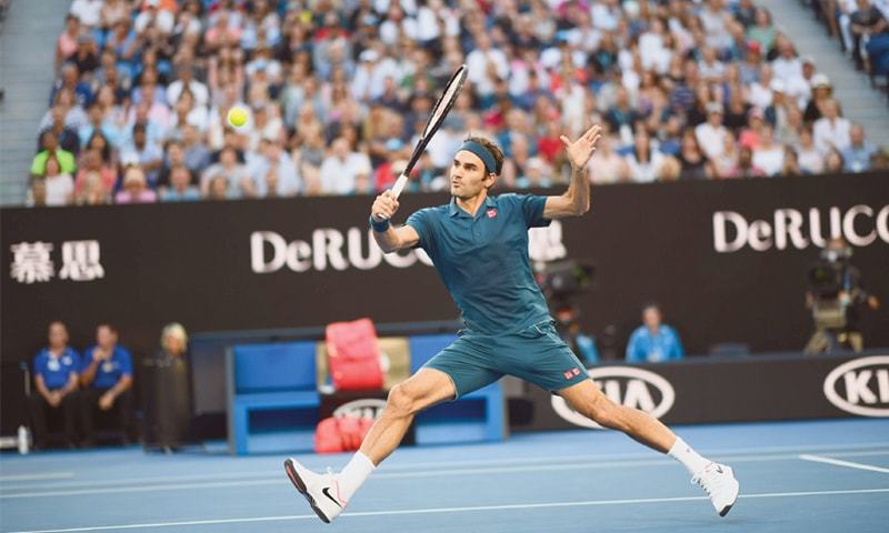 MELBOURNE: Switzerland’s Roger Federer hits a return against Stefanos Tsitsipas of Greece during their match at the Australian Open on Sunday.—AFP