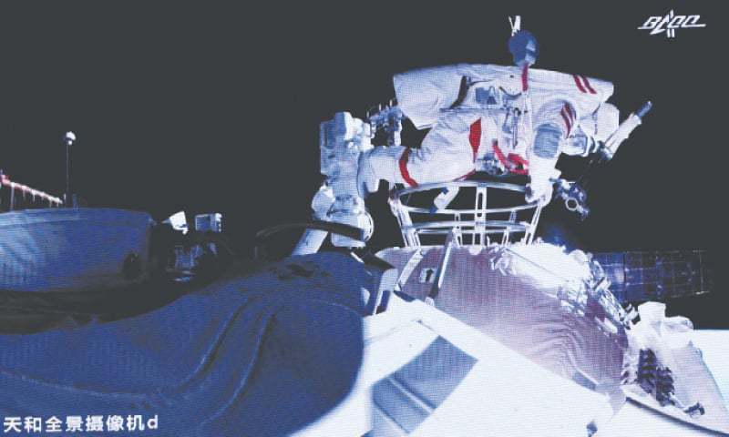 A PHOTO released by Xinhua News Agency shows astronaut Liu Boming stepping out of the core module of the space station.—AP