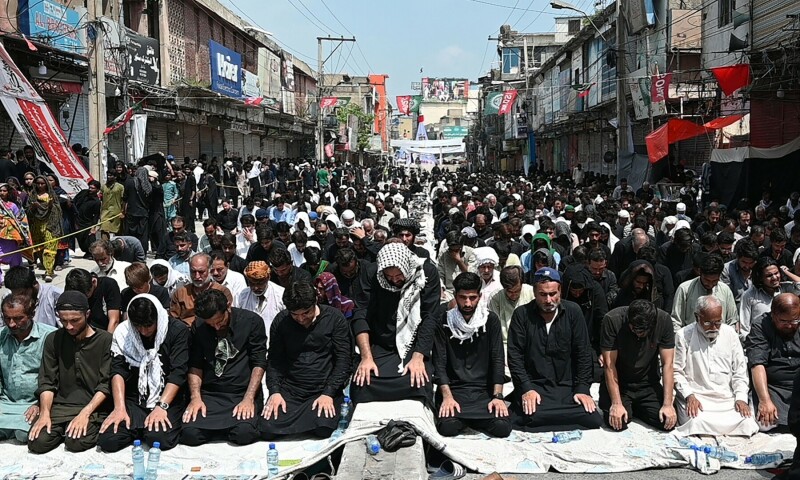 Mourners offer prayers during a procession on the tenth day of Ashura in the first Islamic month of Muharram in Rawalpindi on August 9. — AFP