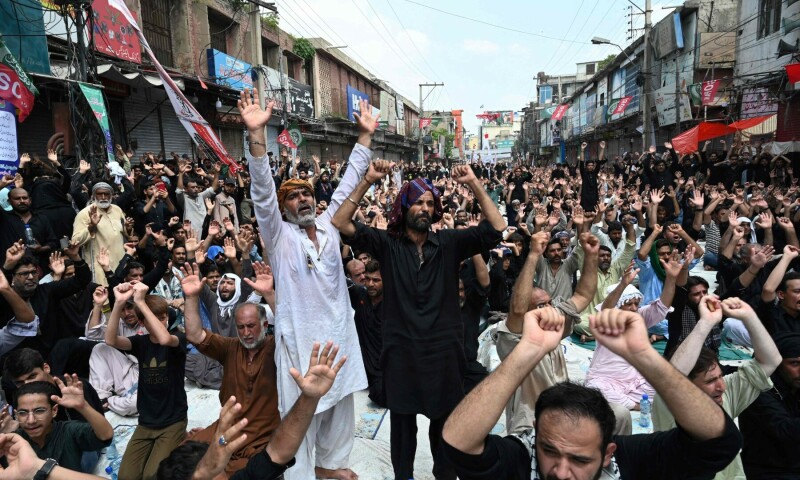 Mourners offer prayers during a procession on the tenth day of Ashura in the first Islamic month of Muharram in Rawalpindi on August 9. — AFP