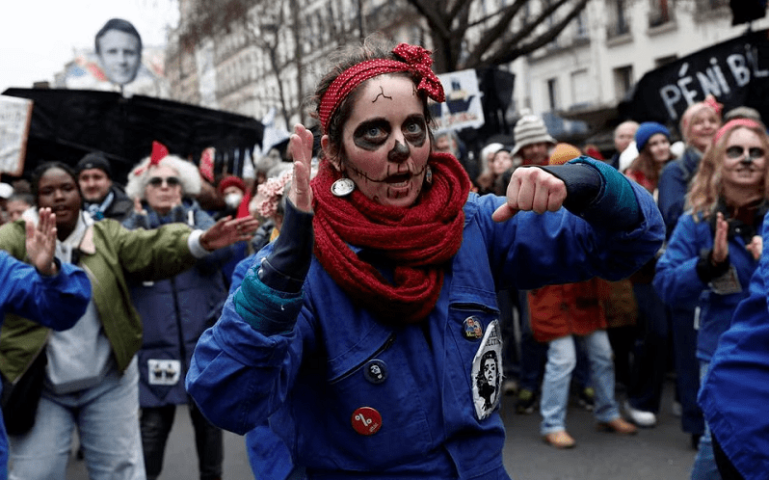  Femimist activists dressed as Rosie the Riveter icon perform during a demonstration against French government’s pension reform plan in Paris as part of a day of national strike and protests in France on Thursday. — Reuters 