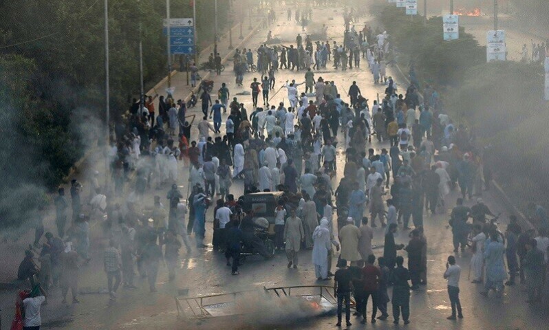 Supporters of Imran Khan block a highway, during a protest against his arrest, in Karachi on Tuesday. — Reuters