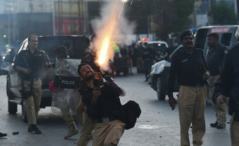 Police fire tear gas shells towards PTI party activists and supporters of Imran during a protest against the arrest of their leader in Karachi on Tuesday. — AFP