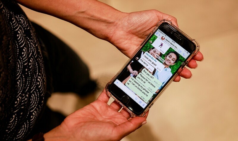 Rachel Goldberg, US-Israeli mother of Hersh Goldberg Polin, which was taken hostage by Hamas, holds a mobile phone displaying text messages with her son at the morning he was taken, in their home in Jerusalem on October 17, 2023. &mdash; Reuters