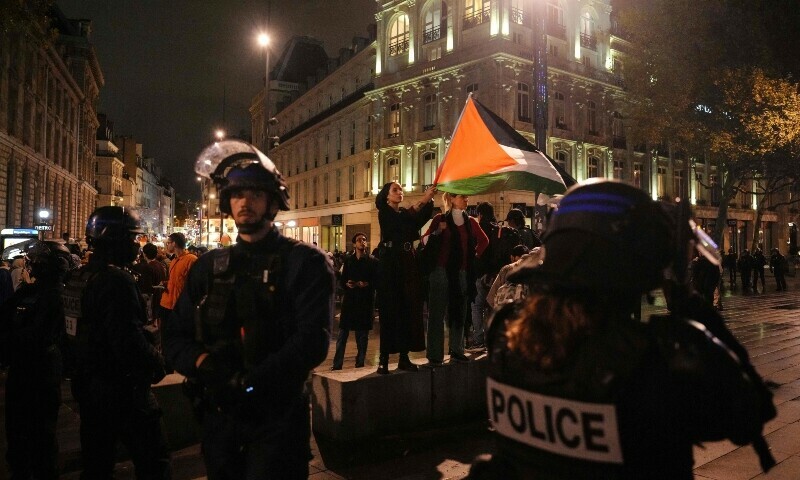 A protester (C) waves a Palestinian flag during a demonstration in support of Palestinians at Place de la Republique during in Paris. &mdash; AFP