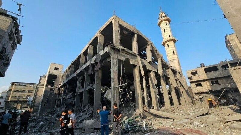 Palestinians gather around the remains of a mosque destroyed in Israeli strikes. &mdash;&nbsp;Reuters