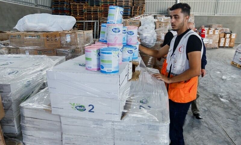 A Red Crescent worker sorts aid before being distributed to Palestinians, as the conflict between Israel and Palestinian Islamist group Hamas continues, in Khan Younis in the southern Gaza Strip. &mdash; Reuters