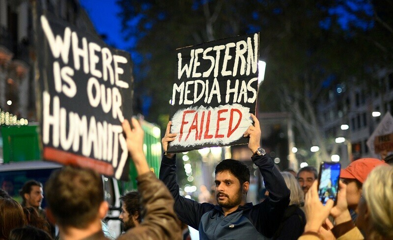 Protestors hold signs as they gather during a demonstration in support of Palestinians, in Barcelona on October 26, 2023. &mdash; AFP 