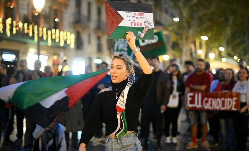  A protestor holds a sign in the colours of a Palestinian flag during a demonstration in support of Palestinians, in Barcelona on October 26, 2023.&mdash; AFP