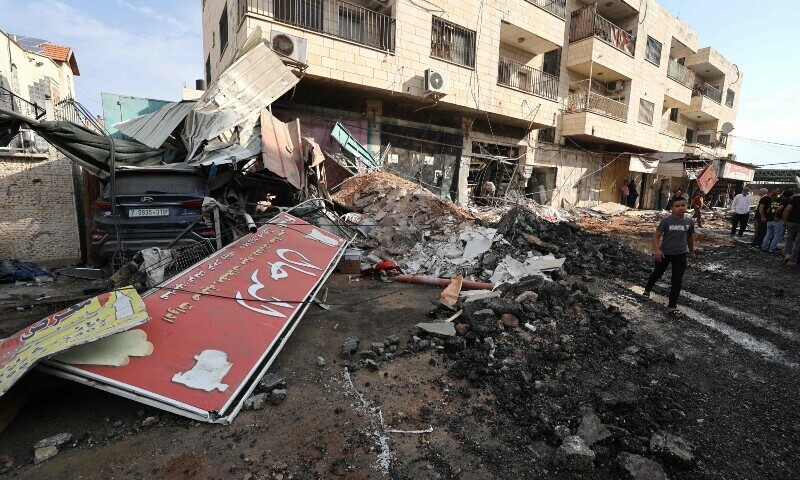 Palestinians look at the damage following an Israeli military raid on the Jenin Palestinian refugee camp, in Jenin in the occupied northern West Bank on October 30, 2023. — AFP