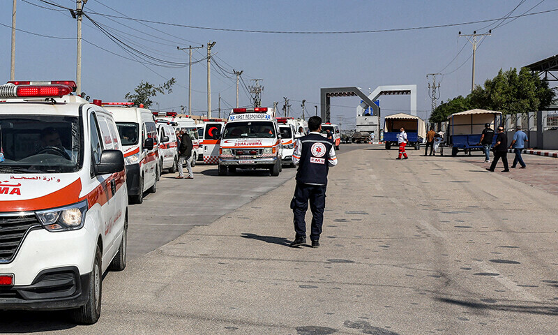 Palestinian health ministry ambulances cross the gate to enter the Rafah border crossing in the southern Gaza Strip before crossing into Egypt on November 1, 2023.—AFP