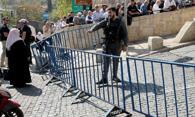 An Israeli border police officer gives instructions to a female Muslim worshipper arriving at the Lion&rsquo;s Gate to make their way to the Al-Aqsa Mosque compound for the Friday Noon prayer in east Jerusalem. &mdash; AFP
