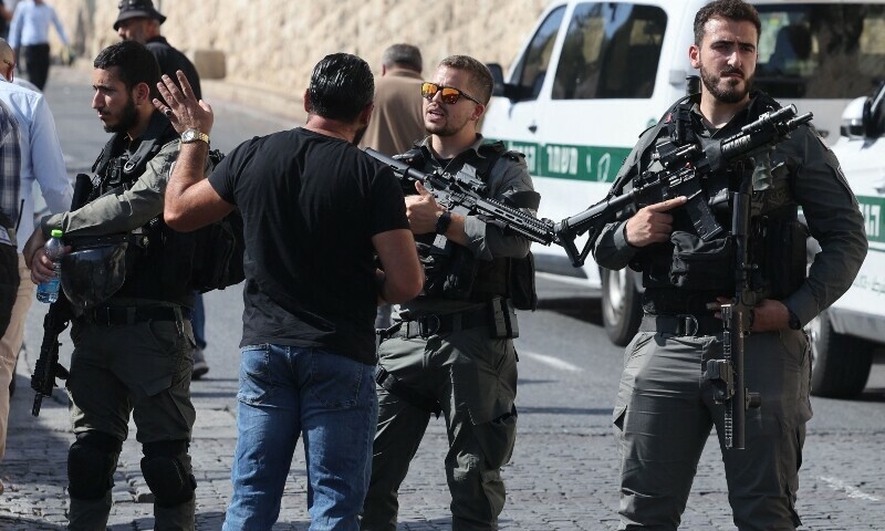An Israeli border police speaks to a Muslim worshipper as he arrives at the Lion&rsquo;s Gate to make their way to the Al-Aqsa Mosque compound for the Friday Noon prayer in east Jerusalem on November 3, 2023. &mdash; AFP
