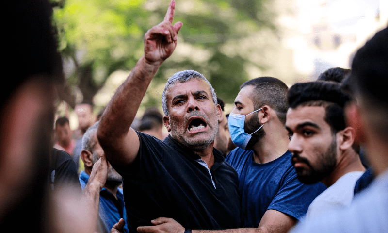  The relative of a victim killed a day earlier in an Israeli strike that hit the entrance of Al-Shifa hospital in Gaza City, reacts during a funeral held for the victims on November 4. &mdash; AFP 