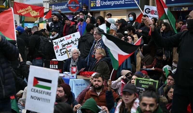 Fundraisers for the Royal British Legion selling poppies find themselves surrounded by Protesters taking part in a sit-down protest inside Charing Cross station following the &lsquo;London Rally For Palestine&rsquo; in, central London on November 4, 2023. &mdash; AFP