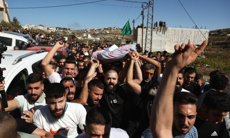 Mourners carry the body of 21-years-old Palestinian Mahmoud Atrash who was killed in an Israeli raid, during his funeral in Halhul near Hebron in the Israeli-occupied West Bank. — Reuters