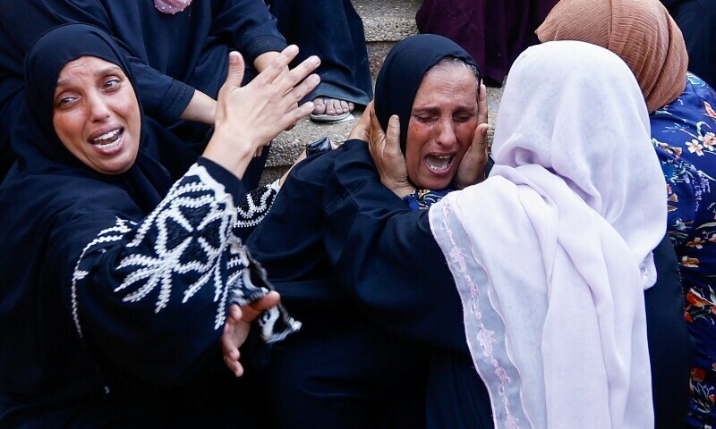 Women react as mourners view bodies of Palestinians killed in Israeli strikes, at Nasser hospital on Nov 8. — Reuters