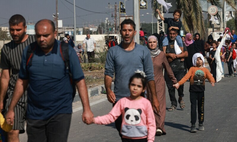 Palestinians, some carrying white flags, walk on a road as they flee Gaza City towards the southern areas on November 8. &mdash; AFP