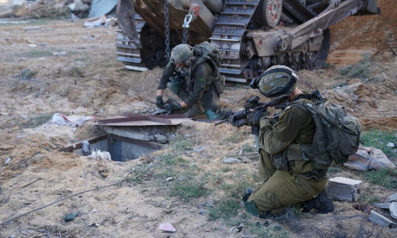 Israeli soldiers inspect the entrance to what they say is a tunnel used by Hamas, during a ground operation in a location given as Gaza. &mdash; Reuters